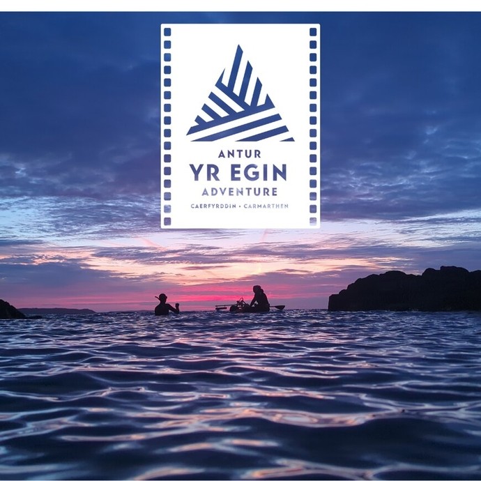 Image: the sea and the silhouettes of two people at sunset on a snorkelling trip; text: Antur Yr Egin Adventure Carmarthen.
